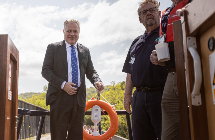 Simon Baynes MP steering The Lady Winifred with volunteer skippers. 